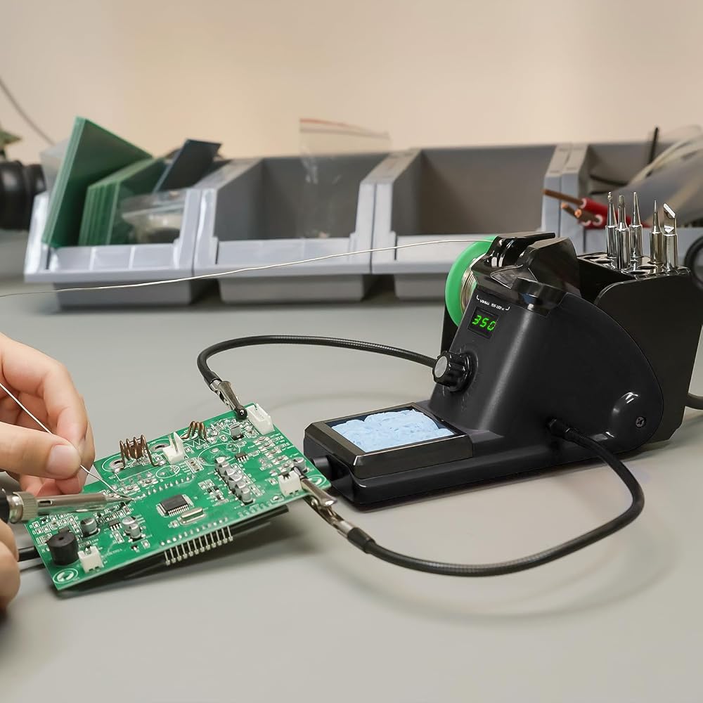 YIHUA 926 III soldering station in use on a workbench with helping hands holding a circuit board