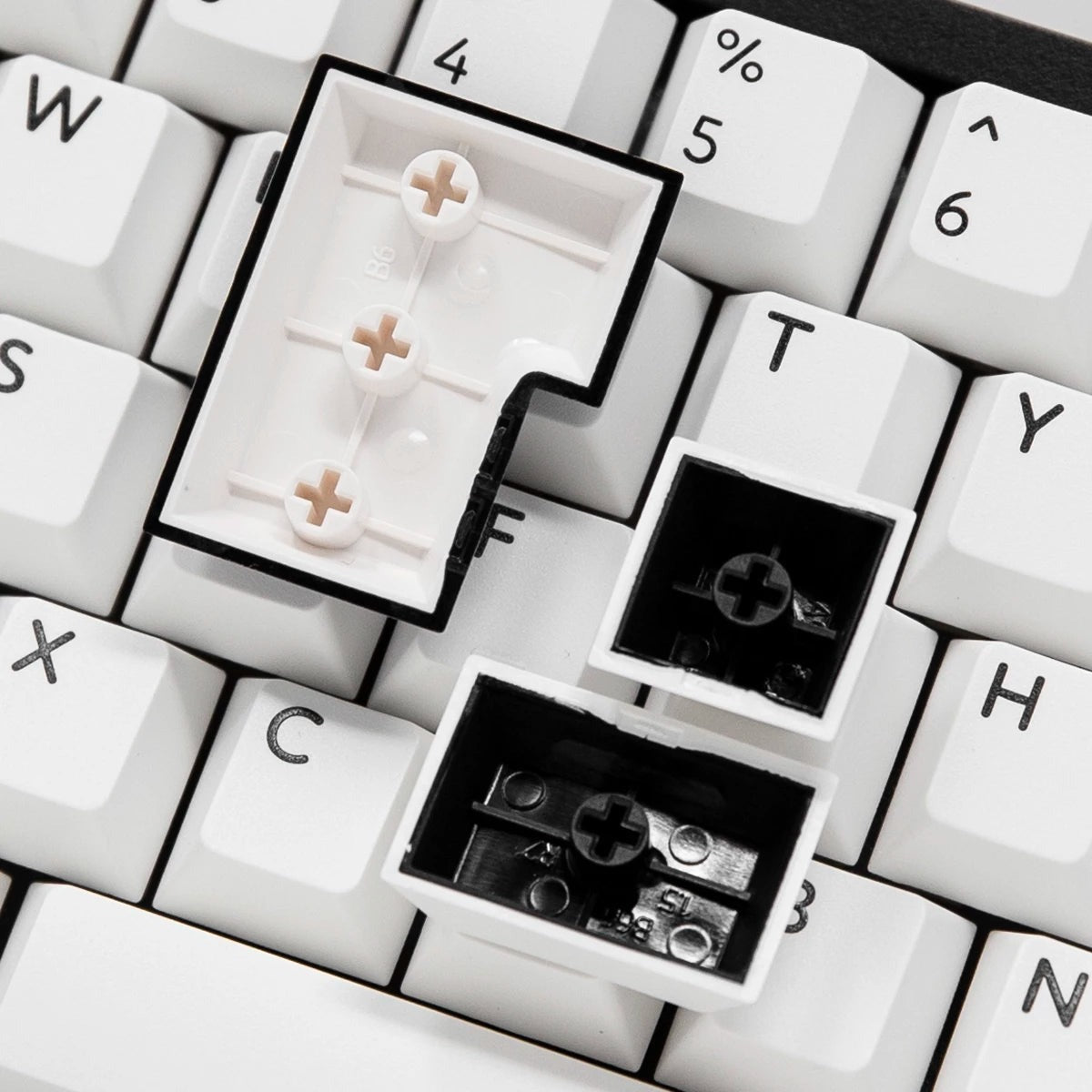 Macro of PBTfans BOW keycap undersides showing doubleshot construction