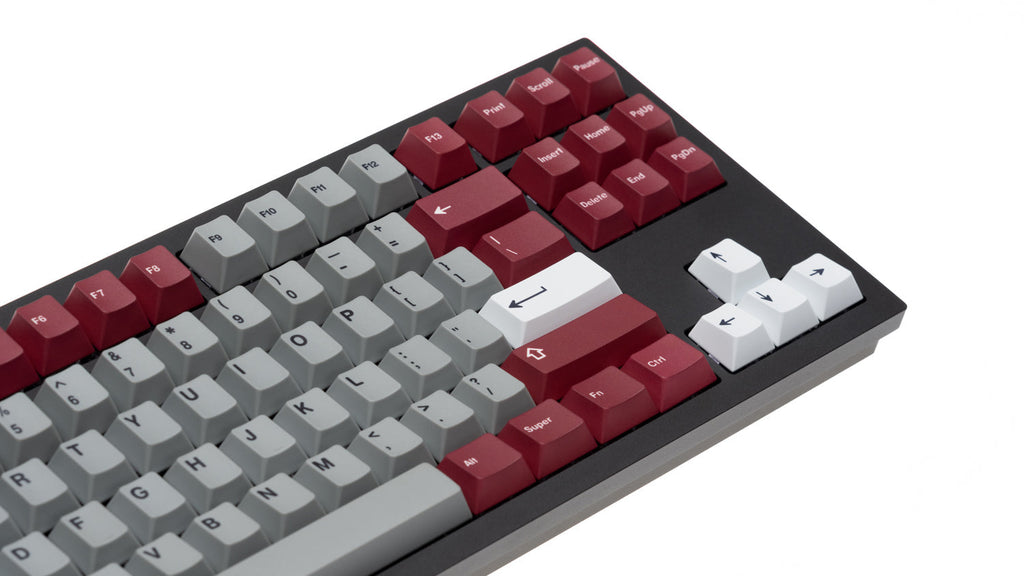 Angled close-up of NicePBT Grey Burgundy keycaps on black keyboard