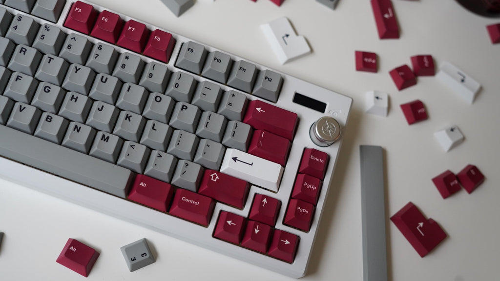 NicePBT Grey Burgundy keycaps on white keyboard with loose keycaps