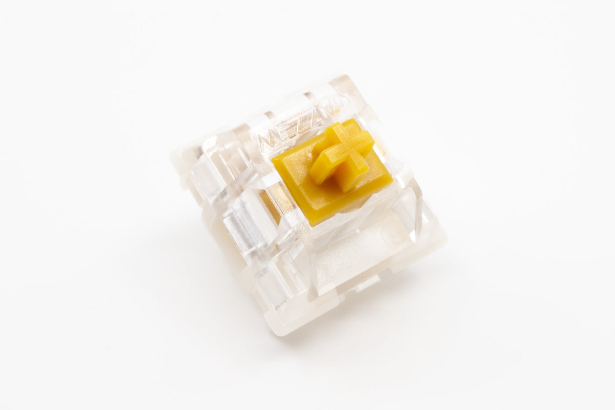 Angled studio view of Gazzew Boba U4T tactile switches with clear housing and yellow stem