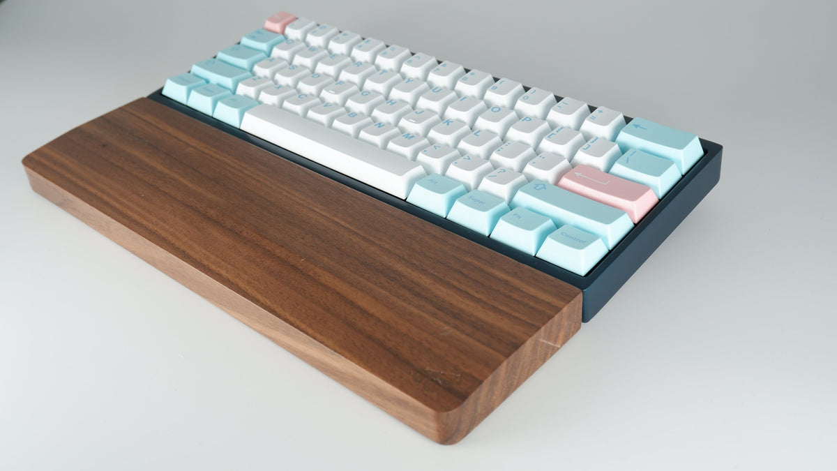 Walnut wooden wrist rest paired with 60 percent keyboard, angled view